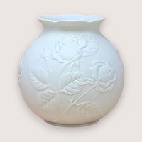 Kaiser West Germany white bisque porcelain vase with a globular body and flared rim. Features a high-relief embossed rose and leaf design with a soft matte finish. 5.5 inches tall.