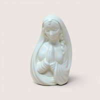Mid-century white ceramic planter featuring a bust of a praying Madonna. Smooth, semi-matte ivory finish, flowing drapery, and serene facial expression. Hollow back for plants or stems.