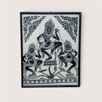 A vertical framed art piece on textured rice paper featuring three Apsara dancers in traditional Cambodian headdresses and poses. Bold black ink on a cream-white background. Framed in a minimalist black wood frame.