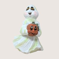 Vintage iridescent ceramic ghost figurine holding a hand painted orange jack o lantern