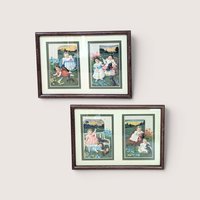 A set of two framed wall hangings, each containing two vintage-style advertising cards featuring Victorian children and puppies in pastoral outdoor settings.