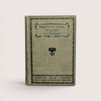 A 1905 hardcover copy of Wilhelm Tell by Schiller, featuring an olive green cloth cover with black ornamental borders and a central heraldic eagle crest.
