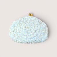 A white beaded and sequined clutch purse with a gold clasp, centered on a beige background.
