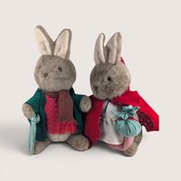 Two vintage Eden Toys Peter Rabbit and Mrs. Rabbit plush bunnies dressed in detailed fabric outfits side by side.