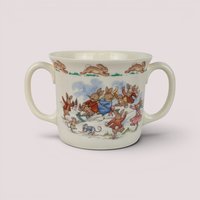 Vintage 1984 Royal Doulton Bunnykins two-handled ceramic cup featuring a colorful winter scene of rabbits sledding.