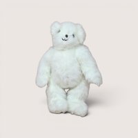 A fluffy white plush teddy bear standing upright and smiling, centered on a beige background.