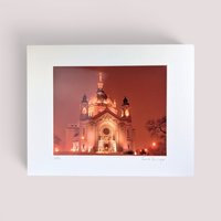 Signed vintage nighttime photography print of the Saint Paul Cathedral in Minnesota matted on a white background.