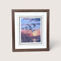 Vintage framed and matted Rhynard Klingbeil wildlife print titled Mallards at Sunset showing ducks flying over a marsh.