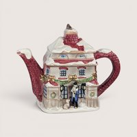 Hand painted Fitz and Floyd ceramic Christmas teapot shaped like a snow covered Dickens style brick cottage.