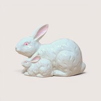 A white ceramic figurine of a mother rabbit and her small baby bunny side-by-side with pink eyes and ears.