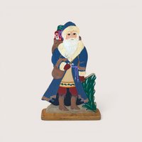 Hand painted wooden Santa Claus figure wearing a blue coat and holding a sack with a matryoshka doll.