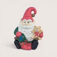 Vintage 1970s ceramic Santa elf music box holding a teddy bear and playing Here Comes Santa Claus.