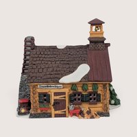 Department 56 Sleepy Hollow School ceramic log cabin schoolhouse with a bell tower and stone chimney.