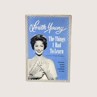 Vintage book cover of The Things I Had To Learn by Loretta Young featuring her portrait on a blue background.