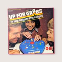 1979 Mattel Up For Grabs vintage board game box cover showing a family playing with a blue plastic peg board.
