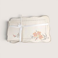 Vintage cream linen Bucilla placemats and napkins set featuring hand-embroidered cross-stitch orange flowers.
