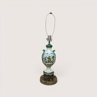 A vintage Italian ceramic table lamp featuring a green and white ornate urn body painted with cherubs.