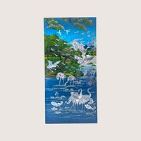 A vintage Asian wall panel featuring a blue landscape scene with detailed iridescent mother of pearl inlaid cranes.