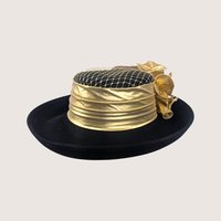 A vintage Sonni San Francisco black wool hat featuring a metallic gold draped band, gold netting, and side bow.