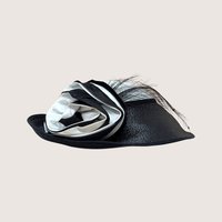A vintage Jody G for Sylvia black and white straw hat featuring a large matching fabric rosette on the side.