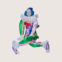 A vintage Bette Ball Victoria Ashlea Originals porcelain clown doll named Jody with blue hair and a colorful satin outfit.