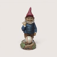 Vintage Tom Clark signed Ump baseball umpire gnome figurine standing behind a baseball on a linen background