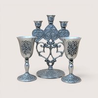 Vintage Carlson Forevermore pewter set consisting of an ornate multi-candle candelabra flanked by two matching goblets with intricate relief patterns.