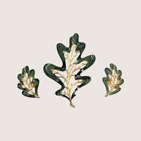 Vintage Sarah Coventry Enchanted Forest green enamel oak leaf brooch and clip on earrings set on a linen background