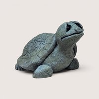 Vintage cast stone or resin turtle figurine with a textured, gray-green finish, featuring a stylized leaf pattern etched into its shell and its head tilted upward, centered on a plain linen background.