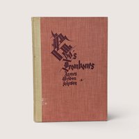 A vintage hardcover book with a textured red cover and stylized black gothic lettering on a plain background