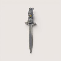 A vintage pewter letter opener featuring a sculpted wizard handle set with two iridescent crystal rhinestones on a plain background