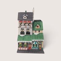 A hand-painted Department 56 porcelain Christmas village building featuring The Chocolate Shoppe and Brown Brothers Books.