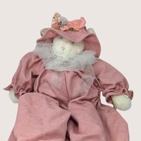 A large vintage 1994 Bunnies By the Bay plush artisan cat doll named Jolie wearing a dusty rose romper and hat.