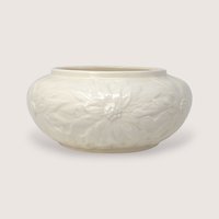 Vintage 1997 cream ceramic bowl featuring embossed holiday poinsettia flower designs around the sides.