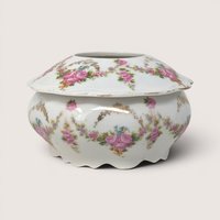Antique M.Z. Austria porcelain hair receiver jar decorated with pink floral swags and a scalloped base.