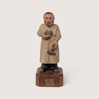 Vintage 1950s Anri Toriart hand-carved wooden apothecary figurine holding medical tools on an octagonal base.