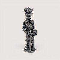 Vintage handcrafted pewter golfer figurine wearing a patterned sweater and cap while holding vintage golf clubs.