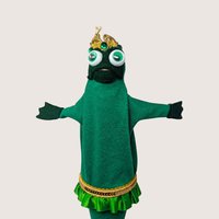 Vintage handmade green felt frog prince puppet wearing a gold crown with googly eyes against a neutral background.