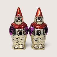 Vintage 1950s clown salt and pepper shakers with metallic finishes, red hats, and ruffs.
