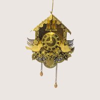 Vintage gold-tone laser-cut metal cuckoo clock ornament featuring hanging chains, dimensional birds, and a slot for a tree light.