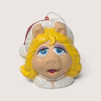 Vintage plastic Muppets Miss Piggy Christmas ornament featuring her classic look and a festive Santa hat.