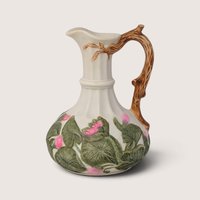 Vintage hand-painted ceramic pitcher vase featuring a tree branch handle and dimensional pink floral relief details.