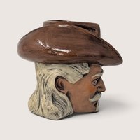 Vintage hand-painted ceramic character mug depicting Buffalo Bill Cody with a sculpted bison handle and "DAD" inscribed on the base.