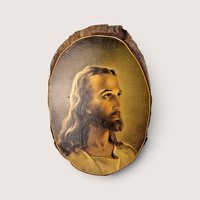 Vintage Warner Sallman Head of Christ reproduction portrait mounted on a natural wood slice plaque.