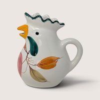 Vintage Italian ceramic chicken creamer featuring hand-painted botanical motifs and a green crest handle design.