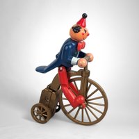 Vintage Plastic Clown on Bicycle Wind-Up Toy: Whimsical Collectible