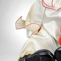 Porcelain Musical Sitting Clown Doll: Whimsical Melody and Delightful Decor