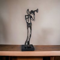 Swingin' Statue: Bronze Horn Player Blows Away in Vintage Charm