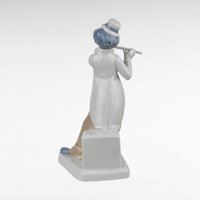 Vintage Porcelain clown figurine holding a flute.