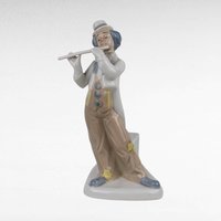 Vintage Porcelain clown figurine holding a flute.